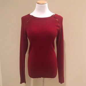 red sweater with golden zippers